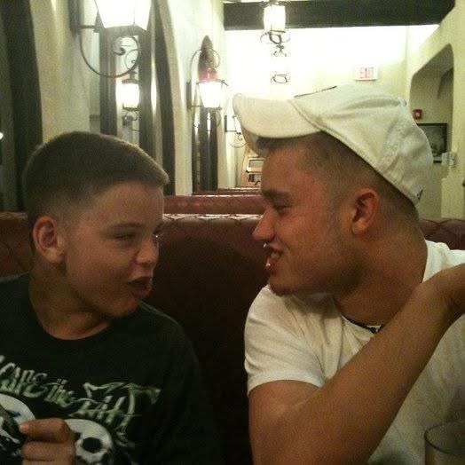 Ryan wearing a cap and looking toward his younger brother