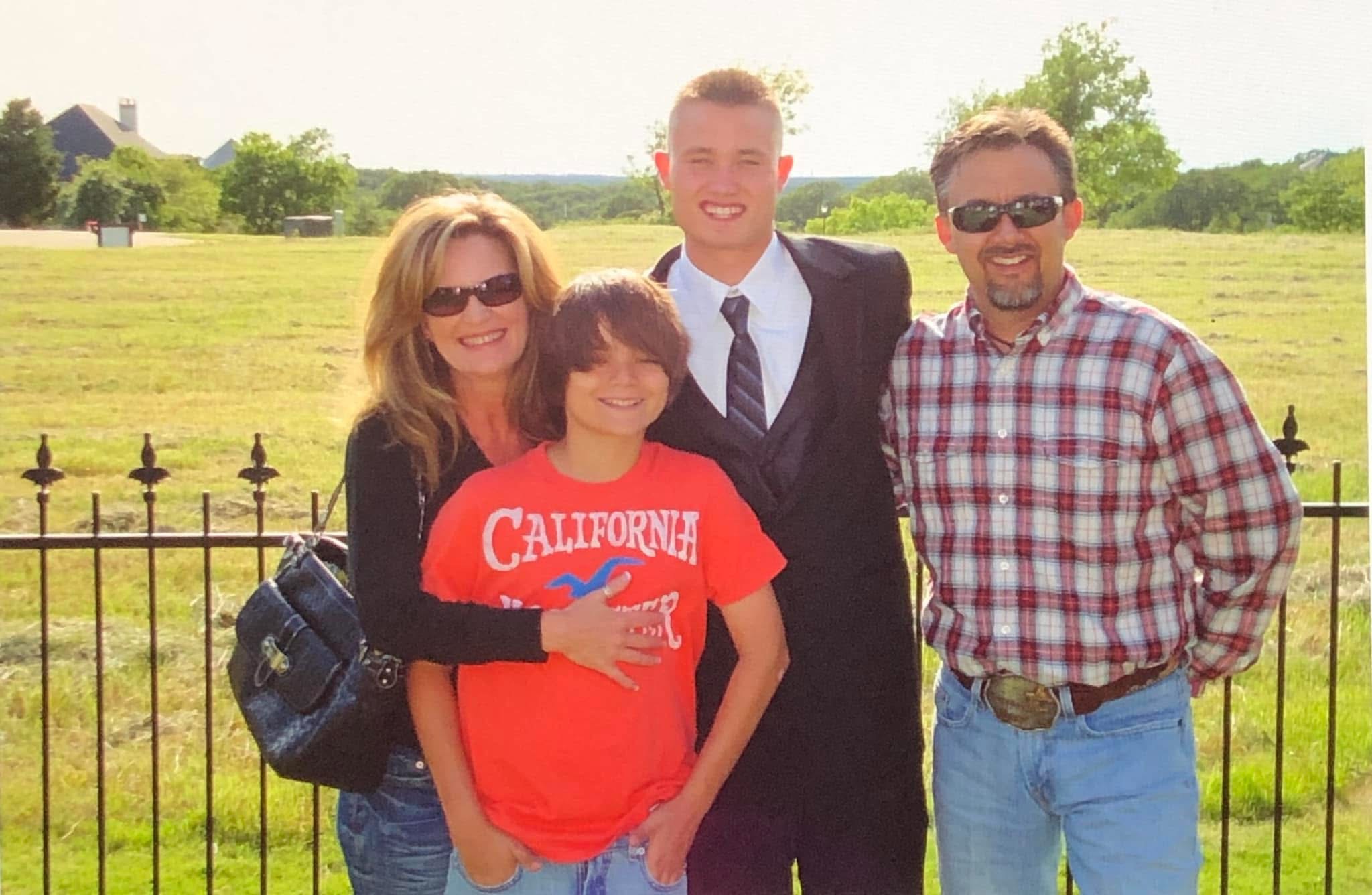 Ryan standing with his family