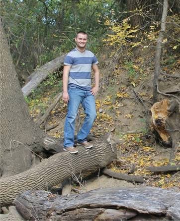 Ryan standing outdoors as a young man