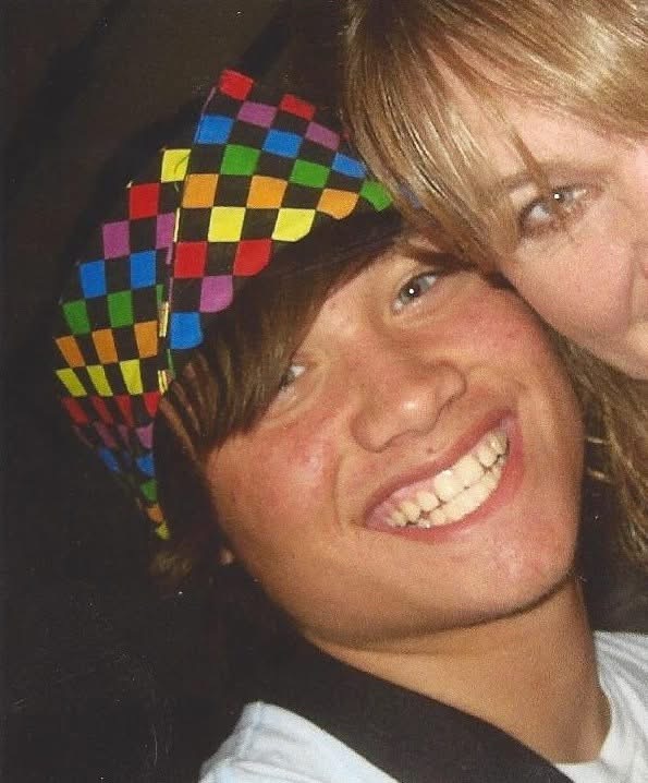 Ryan smiling playfully as a boy