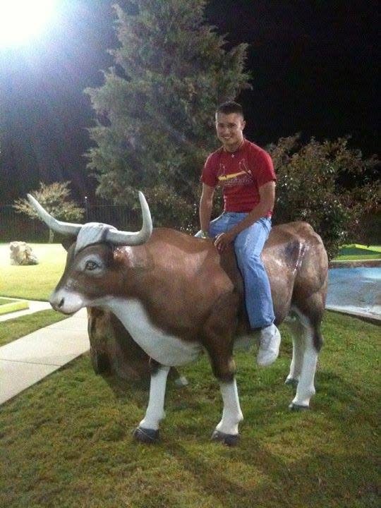 Ryan showing his funny side while sitting on a decorative bull